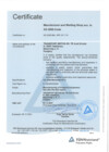 A pale blue certificate page has the word “Certificate” at the upper left and a bold centered title below a thin rule. Labeled entries run down the left side while longer lines of text fill the center and right, over a faint triangular background graphic. A blue triangular seal is printed near the lower right, above a thin footer and small marks.