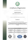 A white certificate page has a narrow gray-green vertical band along the left edge and a small round emblem near the top. The centered heading reads “Certificate of Registration,” above several centered text blocks and a ruled table in the lower half. Circular and oval marks sit along the bottom edge, including a blue oval mark near the center.